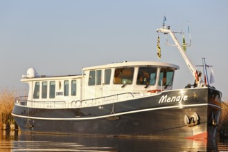 Residential ship on the Peene, tourism, alternative form of living, life on the water with a ship,