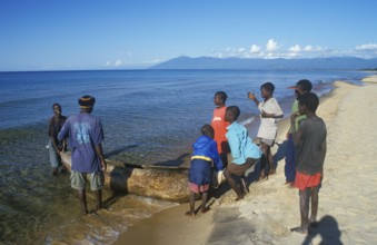 Local men and boys with a dugout near Kande Beach on Lake Malawi, Malawi, Africa, July 2000,