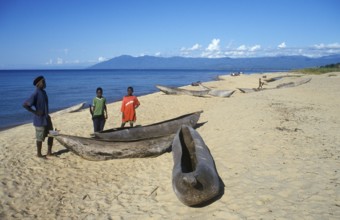 Local man and boy with canoes near Kande Beach on Lake Malawi, Malawi, Africa, July 2000, vintage,