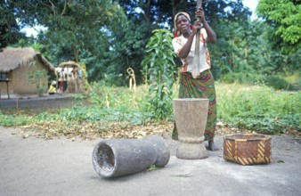 Woman stomping cassava in a village near Kande on Lake Malawi, Malawi, Africa, July 2000, vintage,