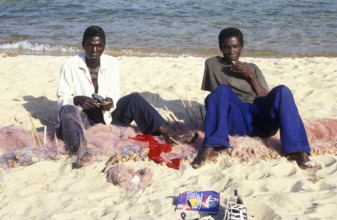 Fishermen at Kande Beach on Lake Malawi repair their nets, Malawi, Africa, July 2000, vintage,