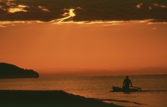 Sunrise over Lake Malawi near Kande, man in dugout, Kande, Malawi, Africa, July 2000, vintage,