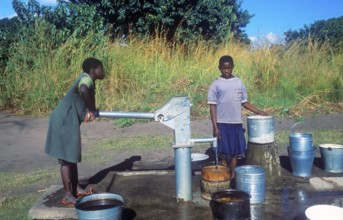 Two young woman at a well in a village near Kande on Lake Malawi, Malawi, Africa, July 2000,