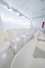 Modern, empty conference room with white chairs in minimalist design, Open Horizons exhibition,