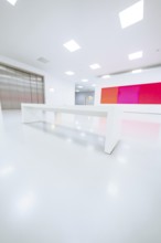 Empty, bright room with white bench and colored painting on the wall, Open Horizons exhibition,