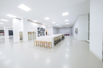 Large, bright room with long tables and chairs, minimalistic modern furniture, Open Horizons