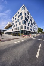 Pedestrian zone, road, lanes, road markings directional arrow, traffic light, commercial building,