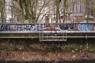 District heating pipeline in front of old industrial buildings on the banks of the Wupper,