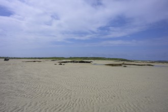 Crossing sandy area at low tide on Omey Island, Sillerna, County Galway, Ireland