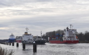 Ships, container ships, cargo ships, tankers meet in front of sunset in the Kiel Canal, NOK, Kiel