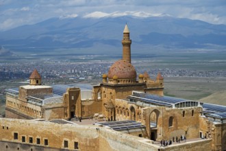 A historic palace with dome, overlooking a city and a mountainous landscape, Ishak Pasha Palace,