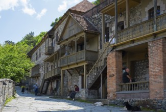 A narrow street with rustic stone houses, people, and relaxed atmosphere, Old Town, Sharambeyan