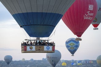 Close-up of a hot air balloon basket with people looking forward to an adventurous ride in clear