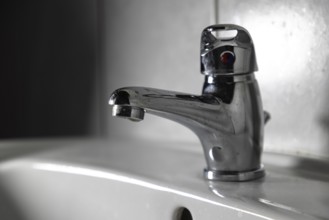 Modern chrome plated faucet in a bathroom