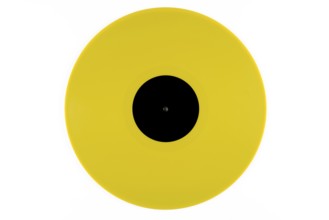 Light yellow phonograph record with a black label in the middle on a white background