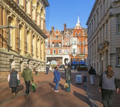 People walking chatting in pedestrianised area, Princes street, town centre of Ipswich, Suffolk,