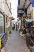 Narrow alley with traditional crafts and decorative objects