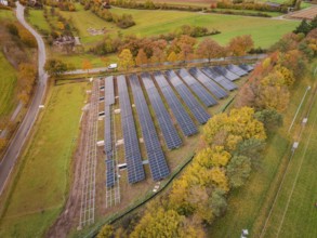 Collection of solar panels surrounded by trees in autumn colors, Bau PV Freifaechenanlage, Weil der