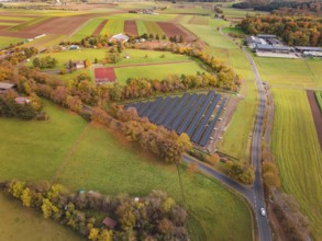 Extensive view of solar systems between fields and autumn trees, Bau PV Freifaechenanlage, Weil der