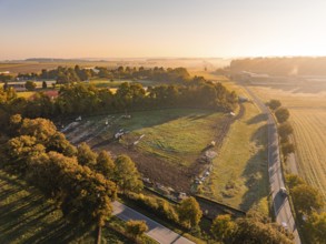 Fields and trees in soft light and light dawn, Bau PV Freifaechenanlage, Weil der Stadt, Germany