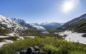 View from Portage Pass of Divide Lake, snowy mountain peaks and glaciers Portage Glacier, Portage