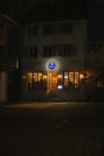 Inviting evening restaurant with illuminated windows and a sign, Sindelfingen, Böblingen district,