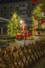 Christmas decorations with gifts and fir trees, illuminated with festive lights, Sindelfingen,