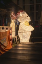 Glowing bear decorated on an atmospheric Christmas night at a Christmas market, Sindelfingen,