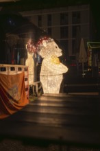 Illuminated bear as part of Christmas decoration in an atmospheric night setting, Sindelfingen,
