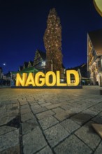 Glowing Nagold lettering at night in the atmospheric city center, Christmas market 2025, Nagold,