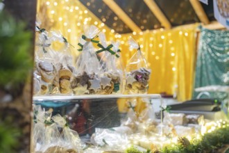 Packaged pastries on a Christmas market stand under twinkling lights, Christmas market 2025,