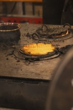 Freshly baked waffles on a hot iron in a Christmas setting, Christmas market 2025, Nagold, Black