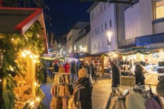 Lively Christmas market at night with stalls and illuminated streets, Christmas market 2025,