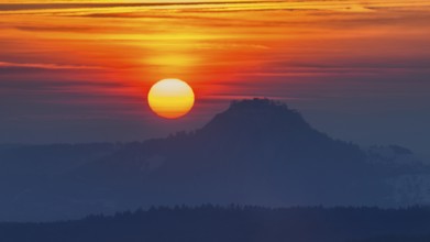 The distinctive silhouette of the Hohentwiel Hegau volcano at sunset, Konstanz district,
