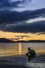 Bronze sculpture El NiÃ±o on the lakeside of Radolfzell am Lake Constance at sunset, Konstanz