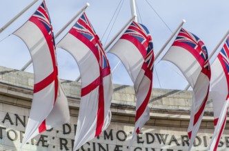 The Admiralty Arch decorated with the flags of the Royal Navy's White Ensign, London England, Great