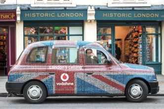 A London taxi with a special taxi advertisement from the London's calling advertising campaign by