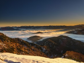Alpine panorama at sunrise in winter, in the fog valley, Untersberg, Marktschellenberg,
