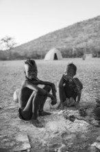 Black and white, Himba children at the fire early in the morning, traditional Himba village,