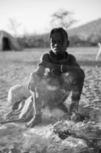 Black and white, Himba child at the fire early in the morning, traditional Himba village,