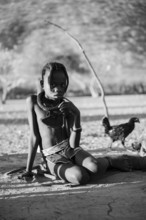 Black and white, Himba child, by the fire in the morning light, traditional Himba village,