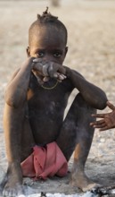 Himba kids at the fire early in the morning, traditional Himba village, Kaokoveld, Kunene, Namibia