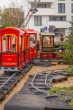 Two children on a toy train ride on an outdoor mini rail track, Sindelfingen, Böblingen district,