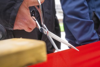 Close-up of scissors cutting a red ribbon at an opening ceremony, Sindelfingen, Böblingen district,