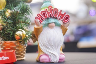 Christmas gnome with 'Ho Ho Ho' sign next to decorated Christmas tree, Sindelfingen, Böblingen