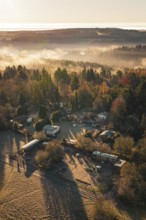 Autumn homestead surrounded by colorful forest and fog at dawn, Gechingen, Hecken and GÃ¤u region,