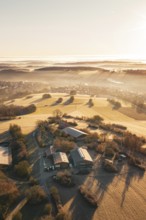 Fields and farm in a slightly foggy, hilly landscape under morning light, Gechingen, Hecken and