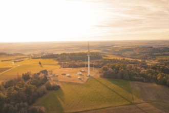 Single radio tower in an open field surrounded by forests in the evening light, Gechingen, Hecken
