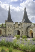 Lavender and double tower behind it with entrance gate at the Abbey of, Le Bec-Hellouin, Eure,