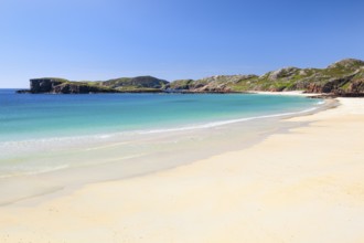 Lonely person on the idyllic sandy beach of Oldshoremore, on the west coast of Scotland